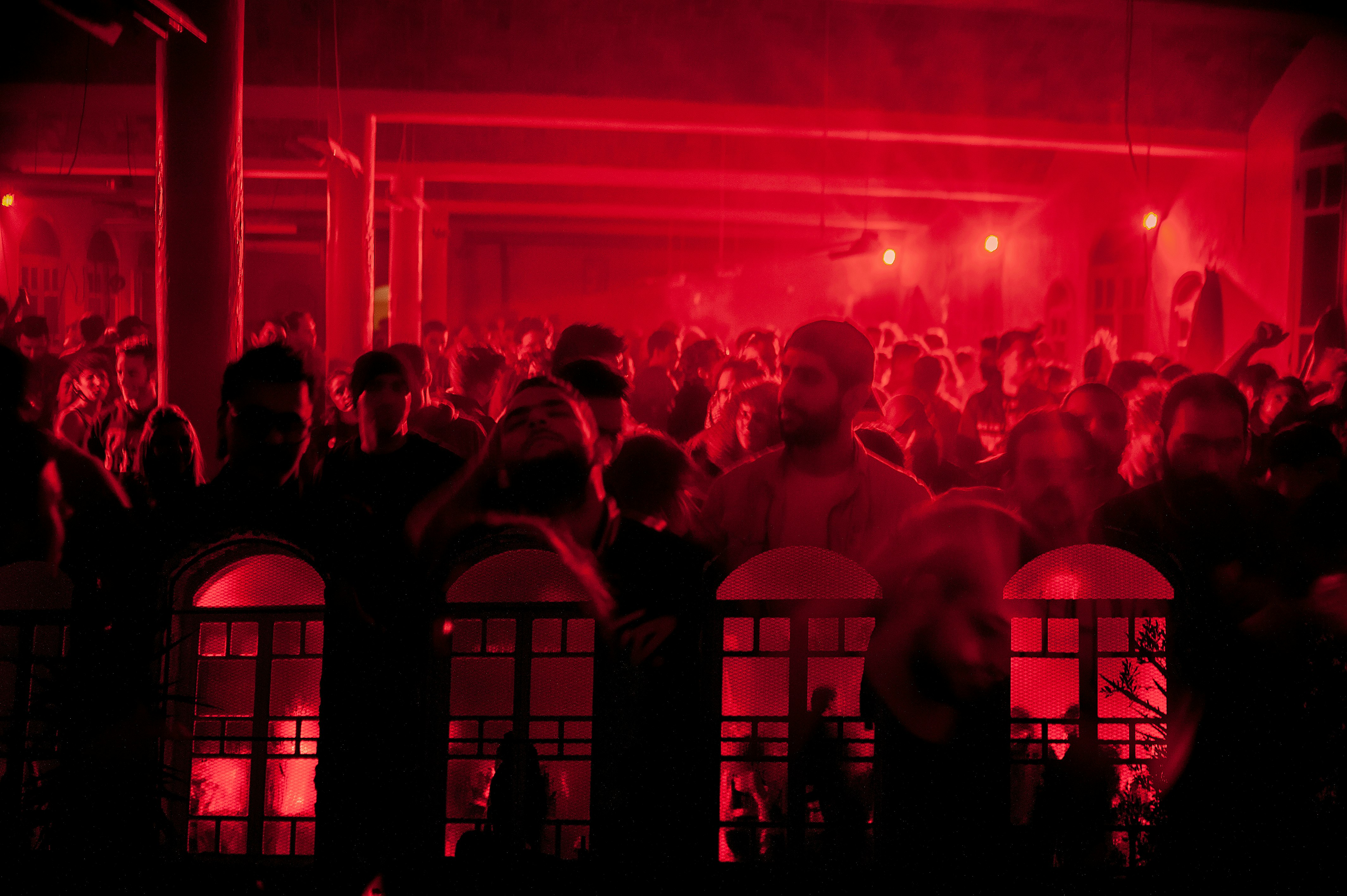 people standing on stage with red lights